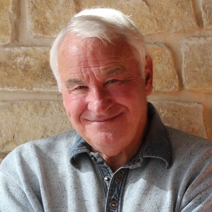 Tom Golisano, a smiling man, portraying the essence of a self-made multi-billionaire and philanthropist.